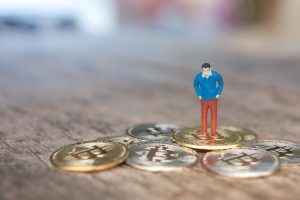 Close Up Figurine With Coins Table 300x200